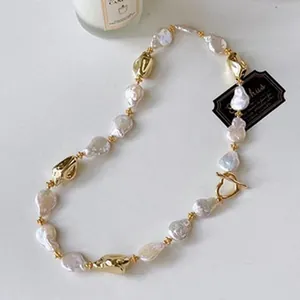 Detailed view of handmade baroque freshwater pearl necklace with gold-toned metal accents