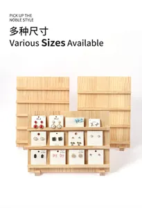 Macro detail of tiered wooden display stand for jewelry and press-on nails on cards