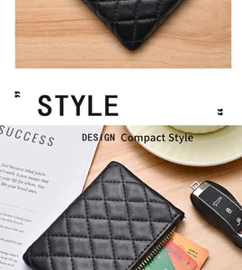 Close-up detail of black quilted leather coin purse with gold zipper and card slots
