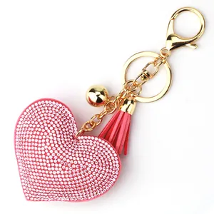 Pink rhinestone heart keychain with matching tassel and gold-tone bell bag charm