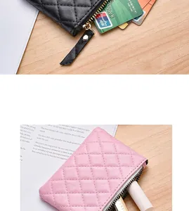 Close-up of quilted pink and black coin purses with smooth zipper detail