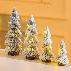 Set of mini snow-flocked Christmas trees with warm LED fairy lights for tabletop decor