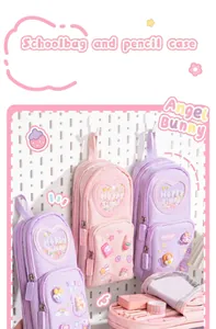 Detailed view of colorful schoolbag-shaped pencil cases featuring multiple layers.