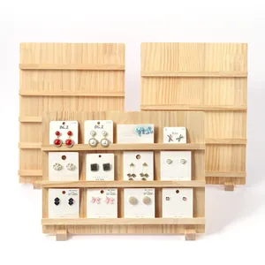 Tiered natural wood display stand with multiple levels for earrings and press-on nails.