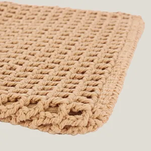 Detailed close-up of a handmade natural cotton woven mesh bag with hollow grid pattern.