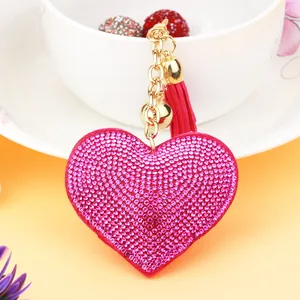 Close-up of a sparkling pink rhinestone heart keychain with a matching tassel