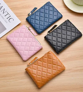 A detailed top-down view showing four quilted coin purses in diverse colors on a desk
