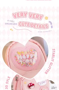 Detail of pink heart-shaped pencil bag with glitter and cute character charm