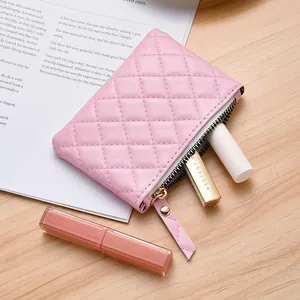 Small pink quilted coin purse with zipper closure and elegant diamond stitching pattern
