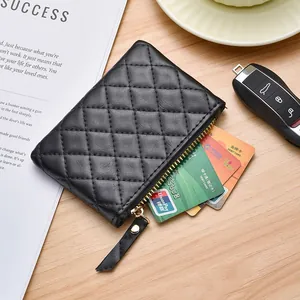 Elegant black quilted leather coin purse with zipper closure and functional card storage