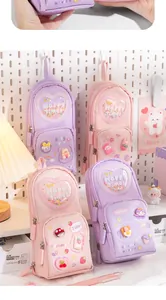 Detailed macro shot of cute pastel pencil cases featuring heart-shaped glitter pockets.
