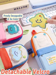 Close-up of detachable cute velcro patches on stylish backpack-shaped stationery pencil bags