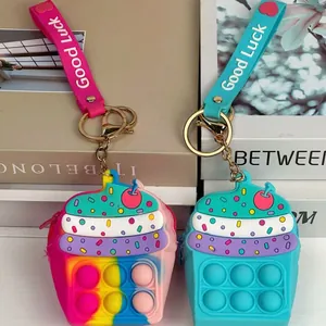 Detailed view of colorful silicone cupcake fidget coin purses with Good Luck straps