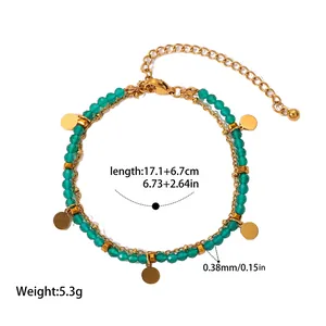 Detail view of multilayer green stone beaded bracelet with gold stainless steel charms