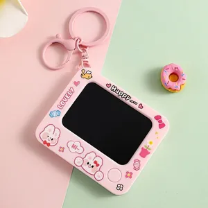 Close-up of a cute pink mini graffiti drawing board keychain with bunny illustrations.