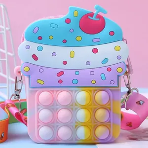Detailed view of a cupcake-shaped silicone pop-it fidget toy shoulder bag for kids.
