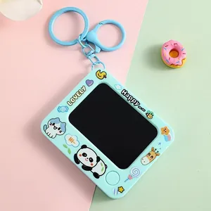 Close-up of cute mini doodle drawing board keychain with cartoon panda and cat motifs