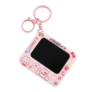 Close-up of pink mini doodle board keychain with cute cartoon bunny and flowers