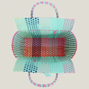 Top view of a colorful hand-woven plastic tote bag for beach and picnic activities
