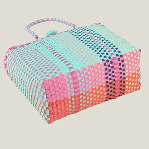 Vibrant colorful hand-woven plastic basket bag ideal for beach picnics and summer vacations