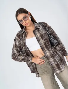 Close-up of the American retro brown plaid shirt featuring distressed texture on model