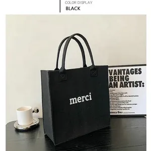 Stylish minimalist black felt tote bag with white merci print and large capacity
