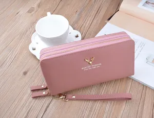 Dettaglio di un portafoglio lungo da donna rosa cipria con doppia zip e logo cervo d'oro
