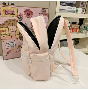 Detailed view of a pink school backpack showing multiple open storage compartments