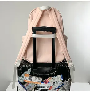 Durable pink travel backpack featuring a practical trolley sleeve for luggage attachment