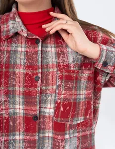Close-up of red and grey vintage plaid flannel shirt showing texture and pocket detail.