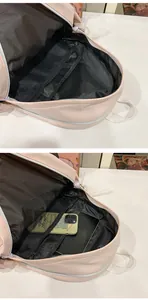 Interior detail of a large capacity pink backpack showing mesh pockets and storage space