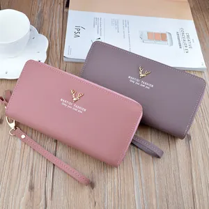 Elegant ladies long wallet with double zippers and wristlet strap in pink and taupe