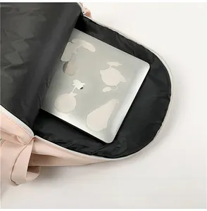 Internal padded laptop sleeve detail inside a casual pink school backpack for students