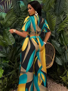 Two-piece women's set with vibrant tropical print, butterfly sleeves, and wide-leg pants