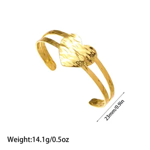 Detail view of golden heart-shaped open cuff bracelet with weight and size info.
