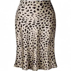 Detail view of high-waisted leopard print satin fishtail skirt showing smooth fabric texture