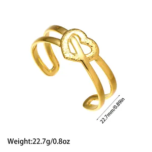 Detailed macro shot of the gold heart cuff bracelet showing its weight and size
