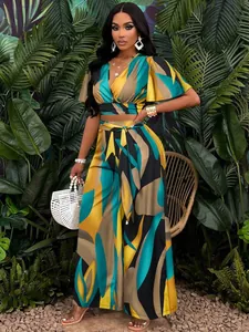 Elegant tropical print two-piece set featuring butterfly sleeves and wide-leg trousers.