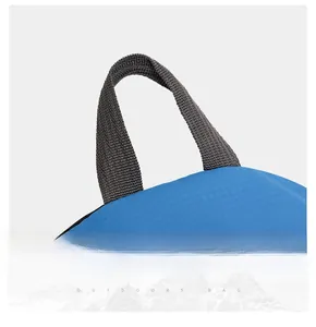 Close-up of the durable gray webbing handle on a blue ripstop outdoor hiking bag