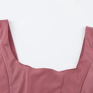 Close-up detail of pink square neck corset top with fishbone stitching style.