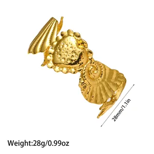 Detail shot of gold stainless steel open bracelet with heart and shell charms.