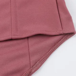 Close-up detail showing the fine stitching and fabric texture of the pink fishbone corset.
