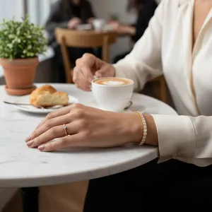 Elegant gold tennis bracelet with shimmering zircons worn in a cafe setting