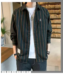 Detail of men's loose long-sleeve shirt featuring vertical dark green and orange stripes