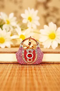 Detailed view of a sparkling rhinestone-encrusted handbag-shaped keychain pendant.
