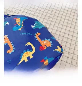 Close-up view of the durable fabric with colorful cartoon dinosaur pattern print