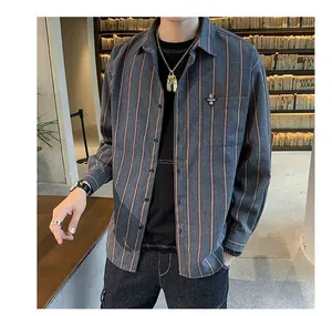 Detail of a grey and orange striped long-sleeved shirt with a trendy chest badge