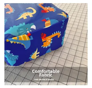 Close-up detail of the durable dinosaur print fabric on the kids' chest bag.