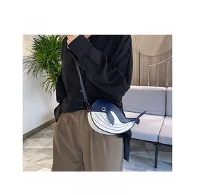 Funny whale-shaped crossbody bag with blue and white color-block design, cartoon style.