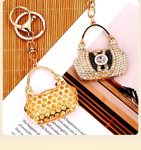 Detail shot of sparkling rhinestone-encrusted handbag keychains on a warm background